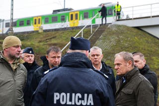 Prime Minister Donald Tusk, second right, visits site of the rail line Mika, that was damaged by sabotage, near Deblin, Poland